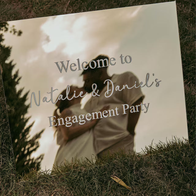 Header image showing a reflective wedding mirror sign with white custom vinyl decals, featuring the text ‘Wedding Decals’ and a welcome message for Natalie and Daniel’s engagement party.