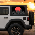 A white SUV parked outdoors at sunset with a large black-and-red window decal showing a pagoda-style city silhouette over a red sun. The scene includes sand, water, and palm fronds in the background.