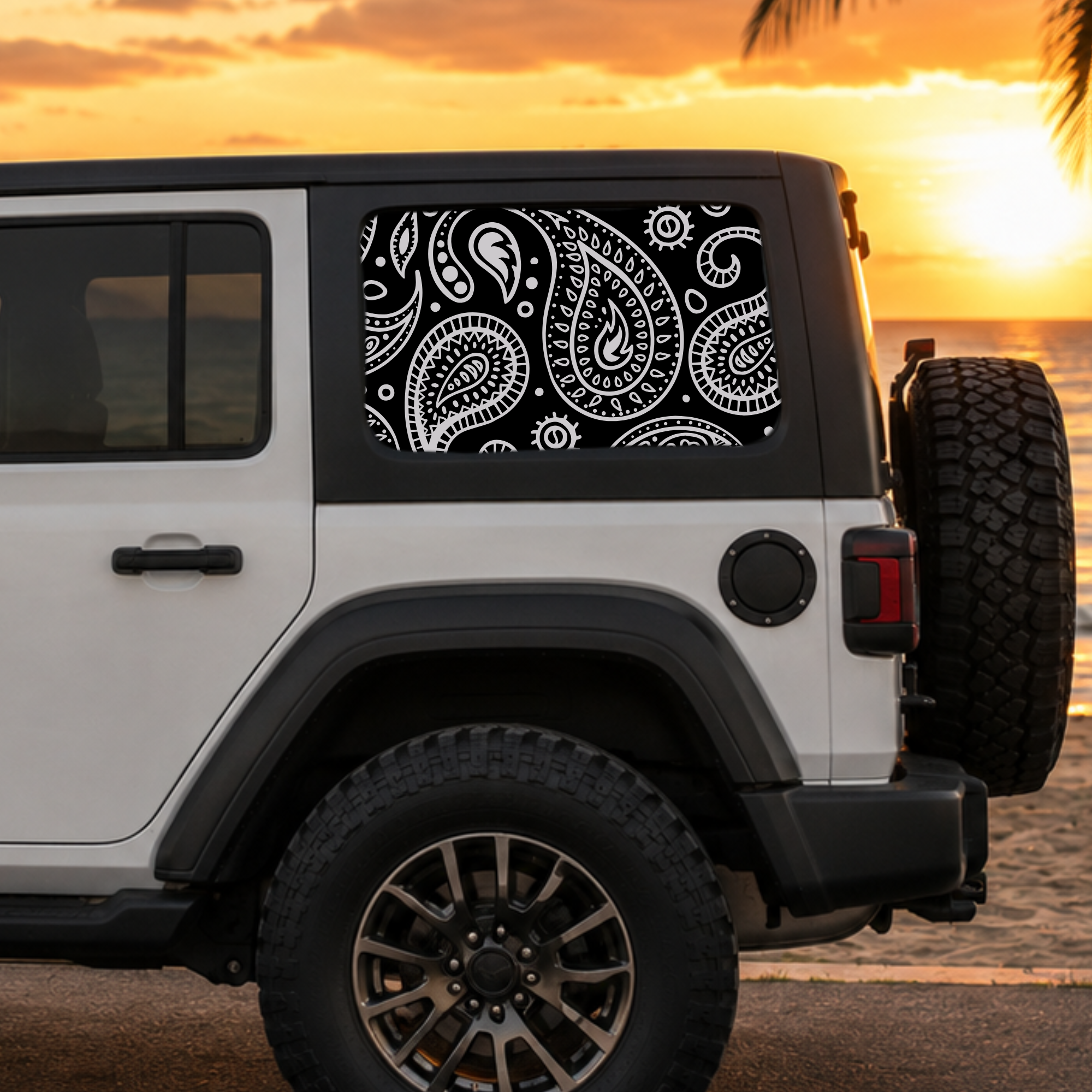 a white jeep with a beach setting background, showcasing a car decal with a paisley pattern design on the rear quarter window
